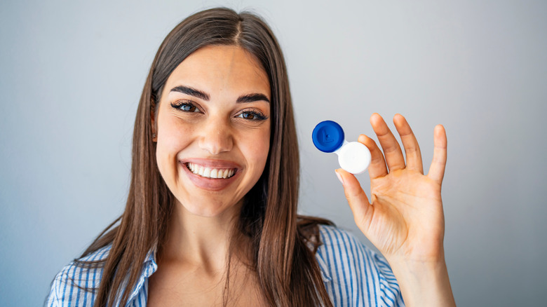 Woman holding a contact lens case