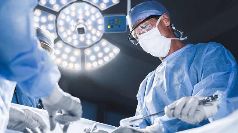 doctor performing surgery in medical facility room