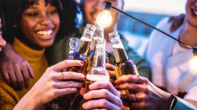a group of friends holding beer bottles