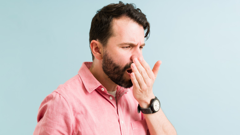 Man checking bad breath