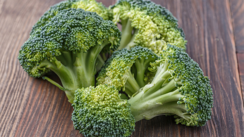 Close up view of broccoli florets on wooden table