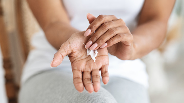person moisturizing hands