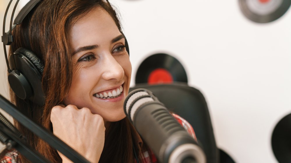 Smiling woman speaking into a microphone