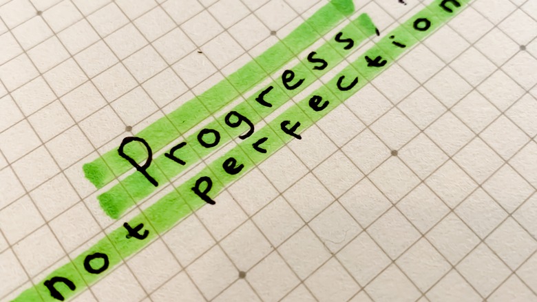 progress not perfection written on graph paper