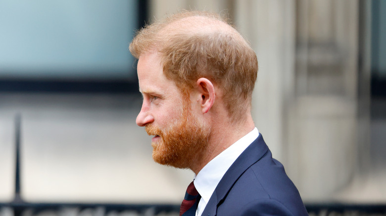 Prince Harry from a side view walking in public