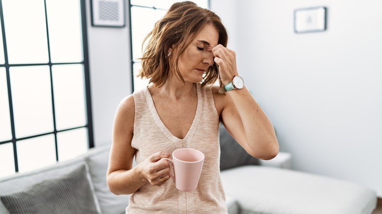 woman with a headache holding her forehead 