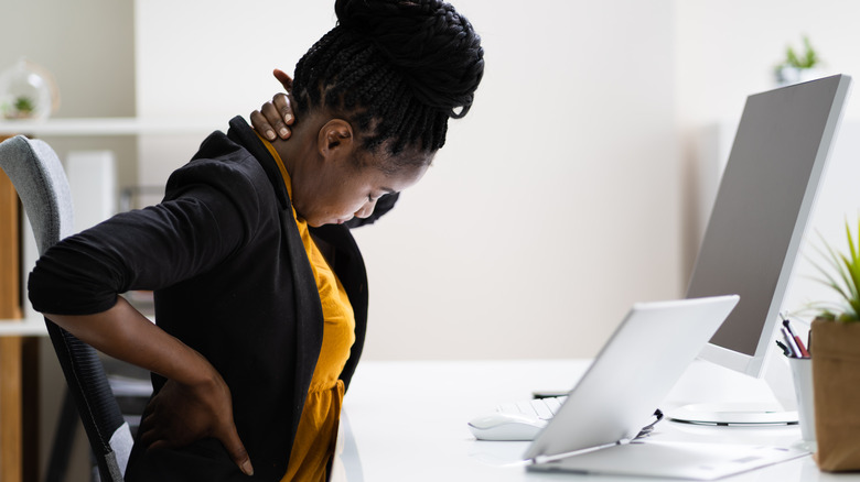 Woman at desk in pain