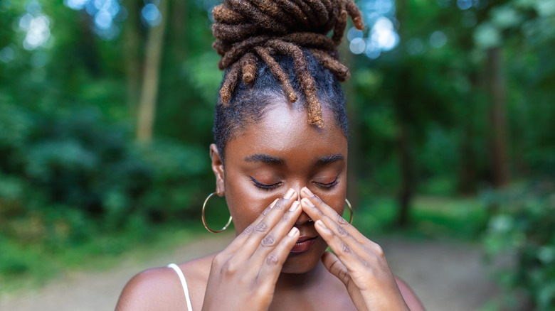 Young woman rubbing her eyes