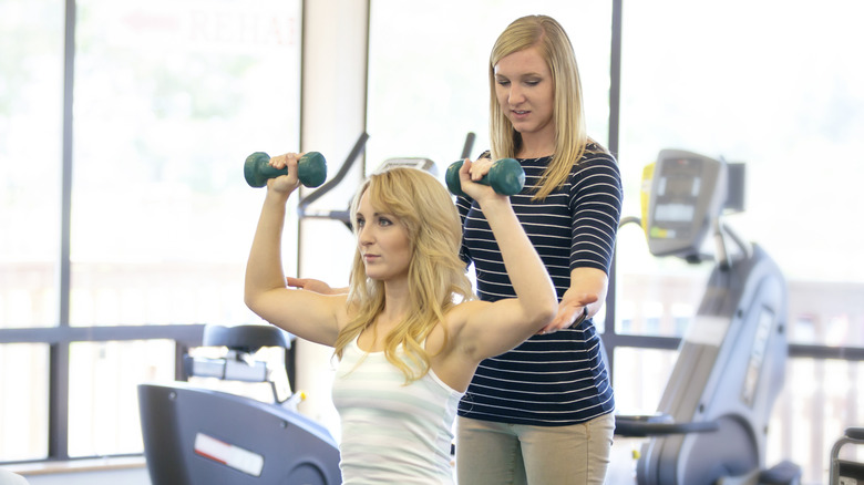 young woman working out with weights
