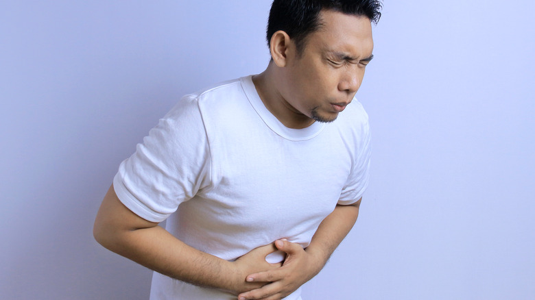 Man holding stomach in pain