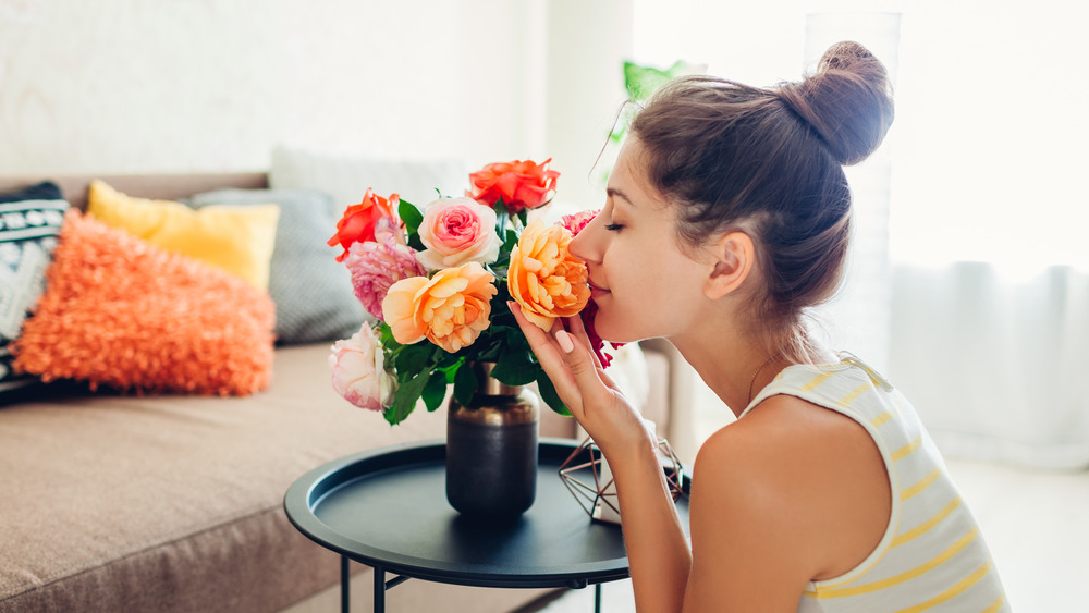 Woman smelling fresh flowers