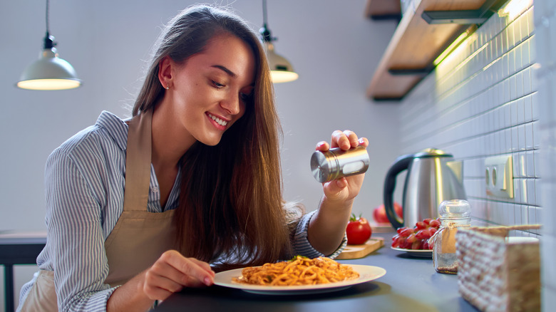 woman adding salt