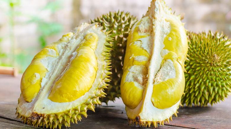 two cut open durian fruits 