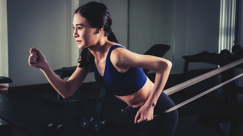 Woman running with resistance band