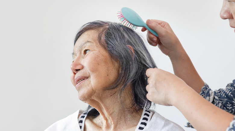 Woman having hair brushed