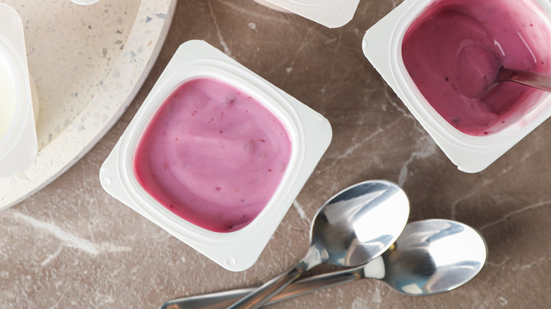 Different flavor yogurts in single serve containers with spoons