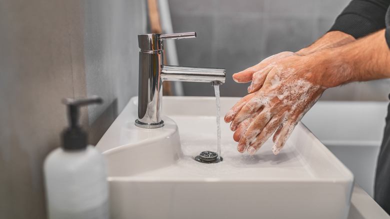 A person washes their hands