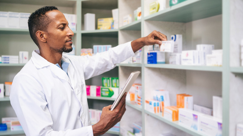 pharmacist arranging medicine on a shelf