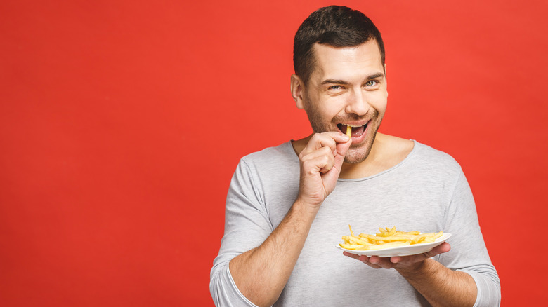 man eating french fries
