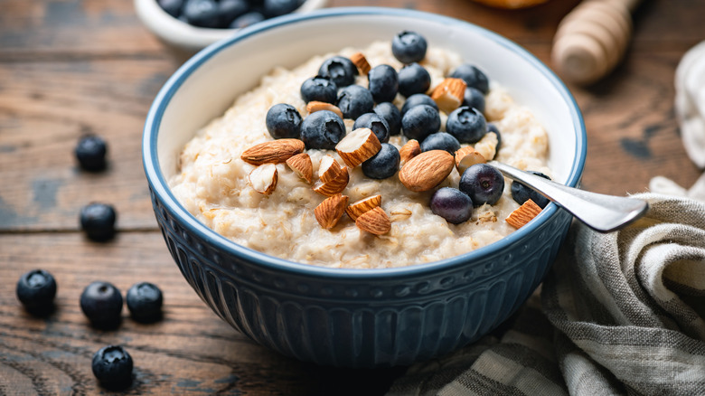 A bowl of oatmeal with blueberries and almonds