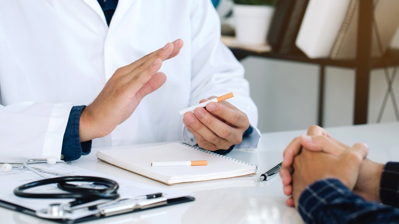 A doctor talks to a patient about smoking