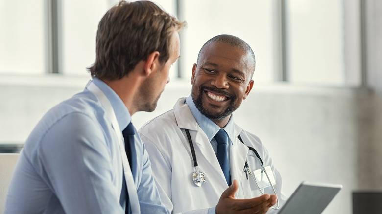 man speaking with doctor