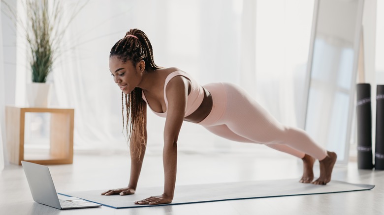 a young woman doing planks 