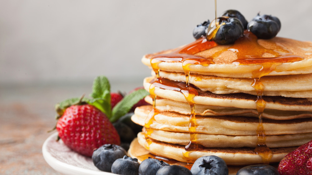 stack of pancakes drizzled with syrup 