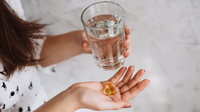 fish oil caplets in hand