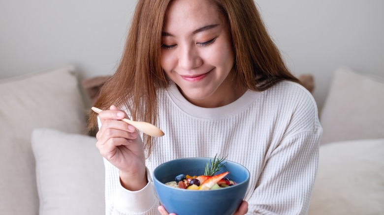 woman eating a smoothie bowl