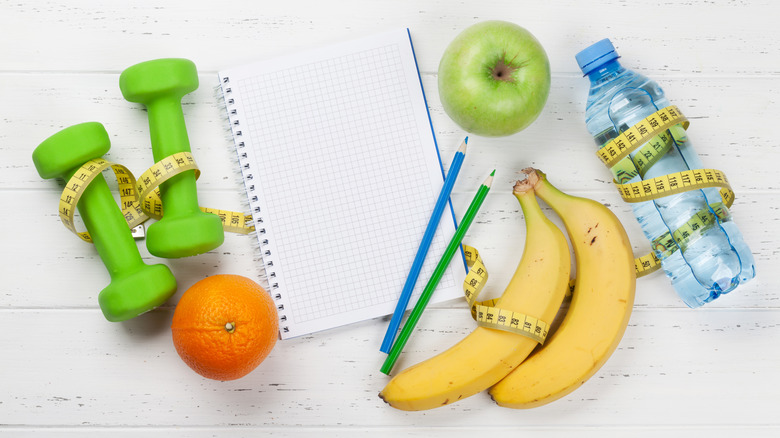dumbells, fruit, and water 