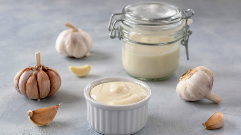 Garlic in several forms from bulb to clove to a spread