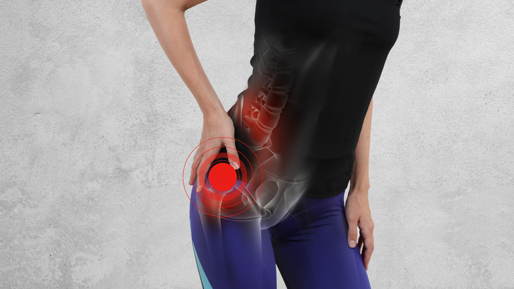 Woman with hand on hip with pain