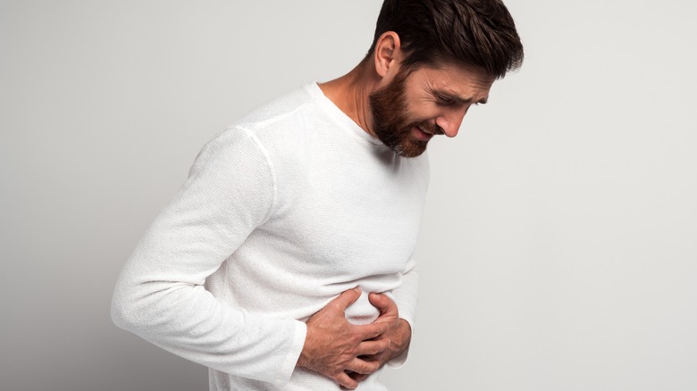 Man clutching his stomach