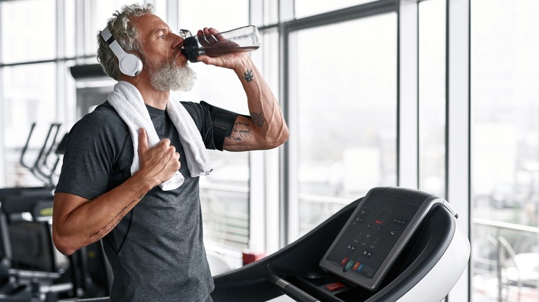 A runner drinking water