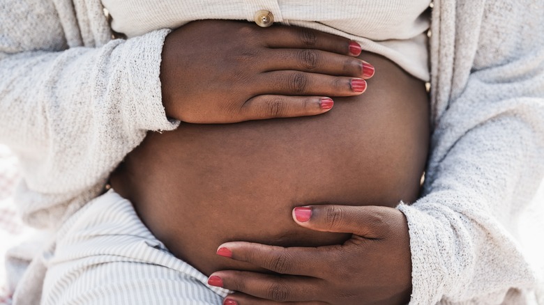 woman holding pregnant belly
