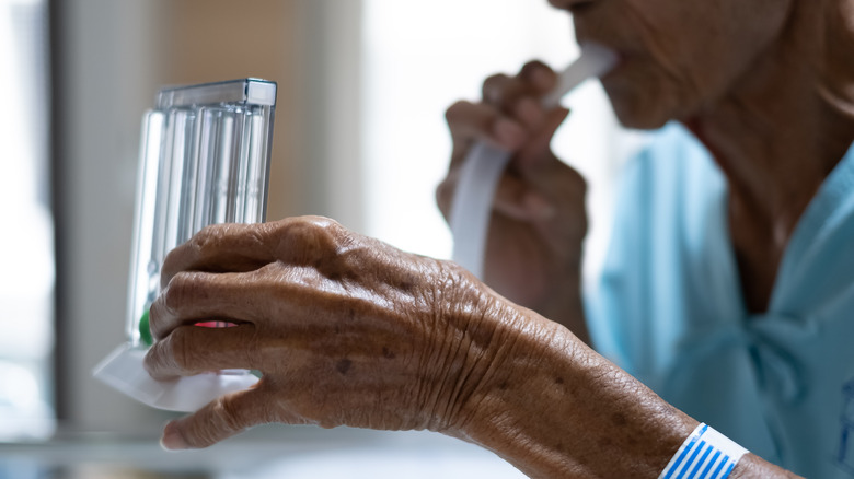 Man holding incentive spirometer