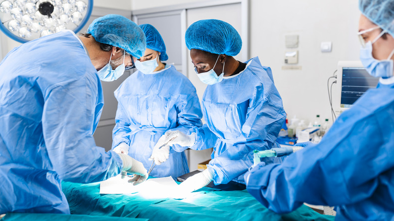 doctors performing surgery on patient