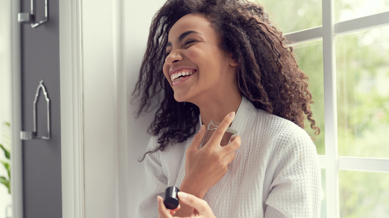 woman spraying perfume