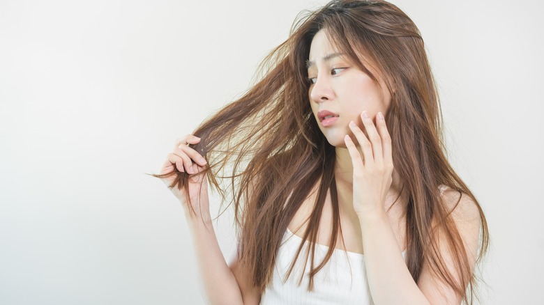 woman looking at dry hair