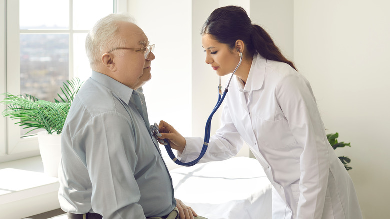 cardiologist listening to heart