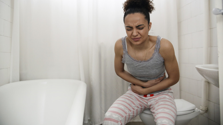 Woman experiencing constipation