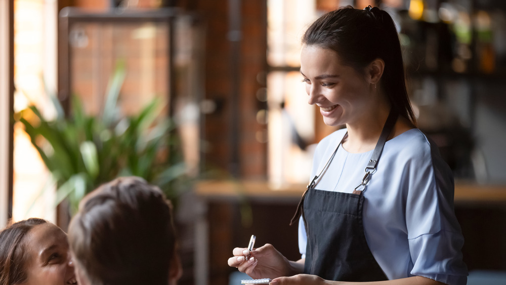 Waitress taking order at table