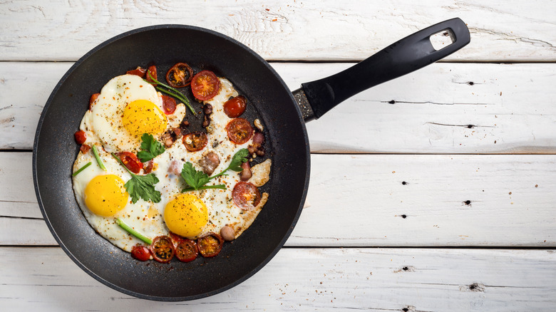 Bacon and eggs cooked in a pan