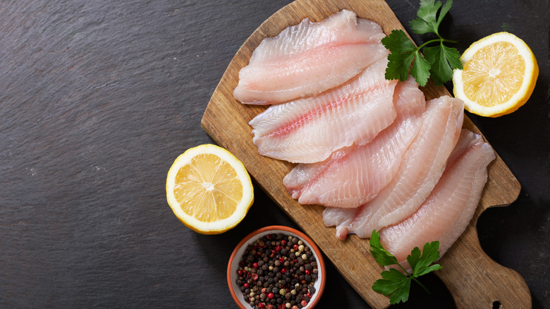 top view of raw fresh tilapia on a cutting board 