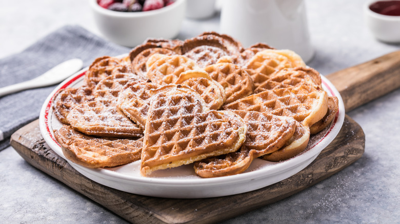 A plate of heart-shaped waffles on a table