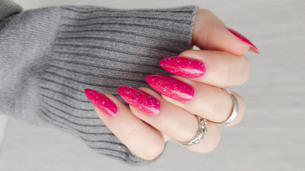 Close up of hot pink acrylic nails