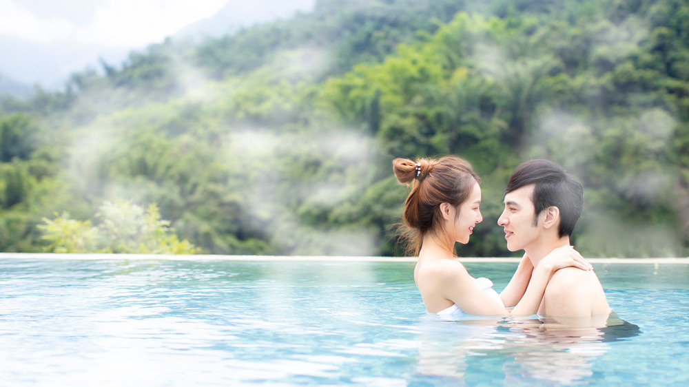 Couple hugging in water