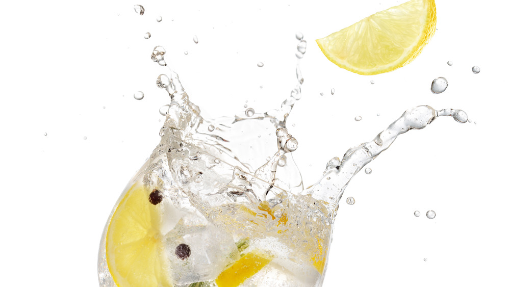 Lemon splashing into a drink