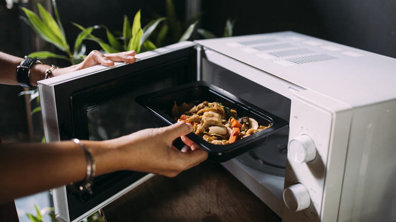 Woman reheating food